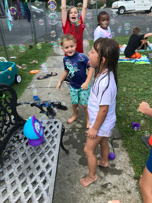 children playing outside with bubbles